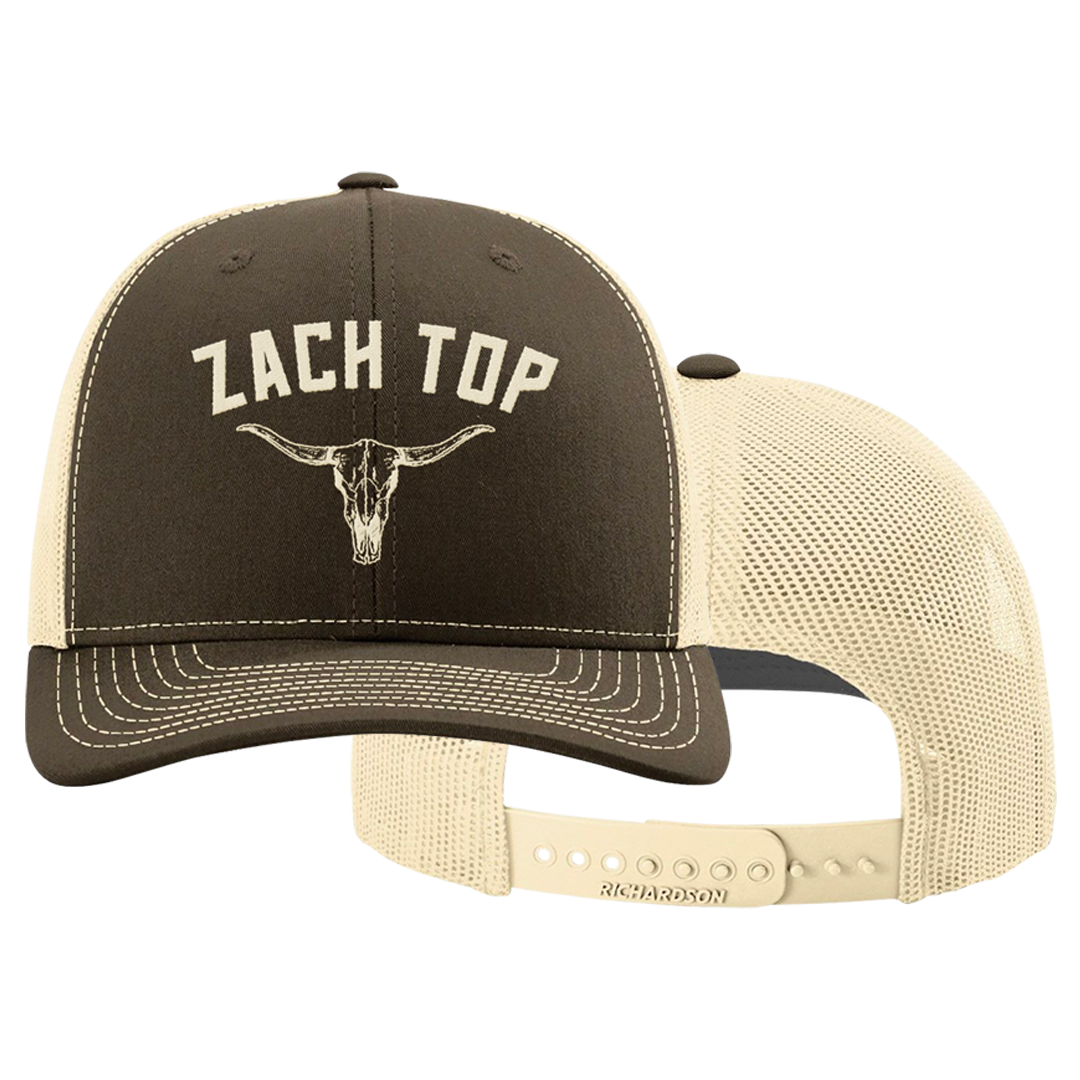 Trucker-style baseball cap with ’ZACH TOP’ text and longhorn skull logo on the front panel.